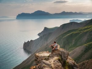 Young man travels alone on the backdrop of the mountains