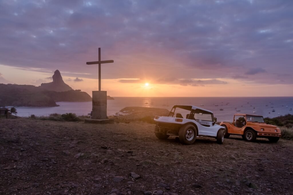 Buggies and Chapel of Sao Pedro dos Pescadores with Morro do Pico - Fernando de Noronha, Brazil