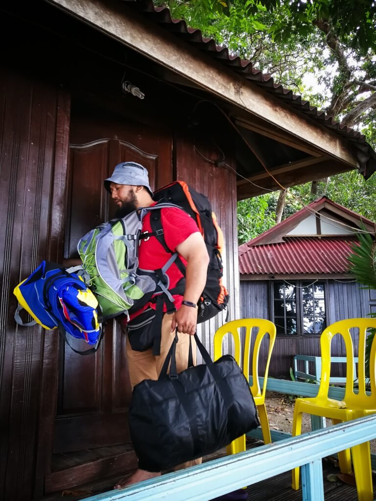 Travelling to the resort with lots of bags. Bearded man backpacker man carrying bags.
