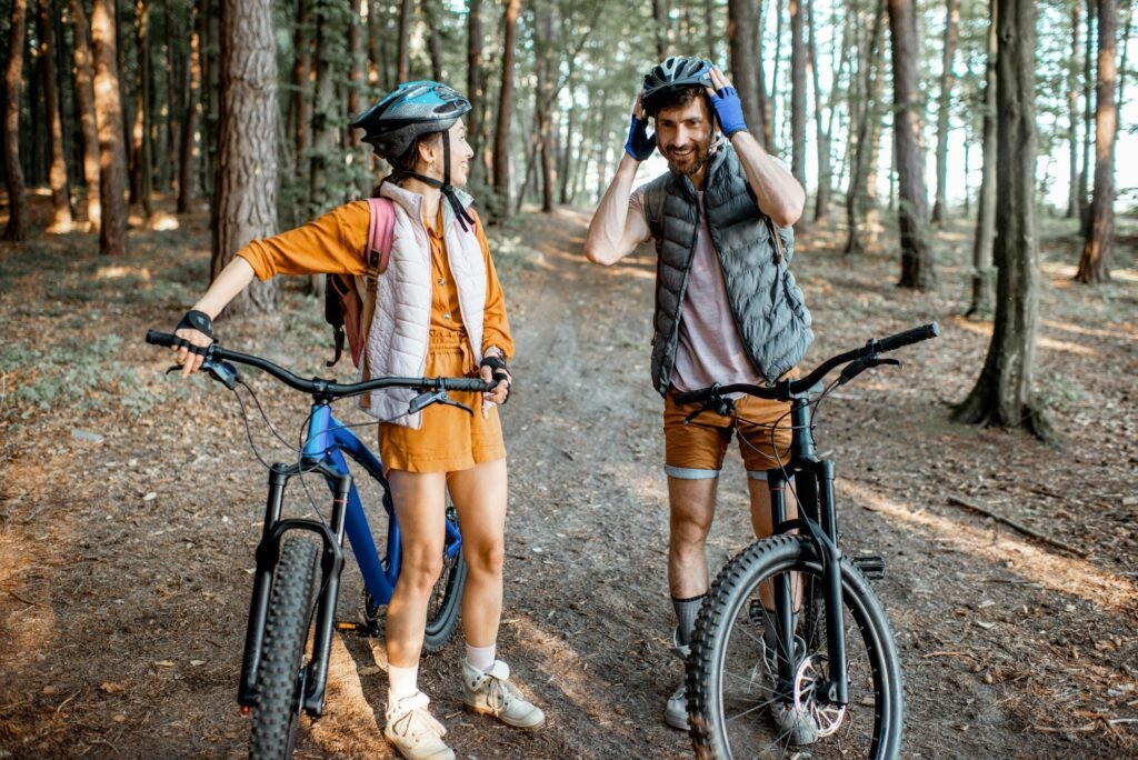 Couple traveling with bicycles in the forest