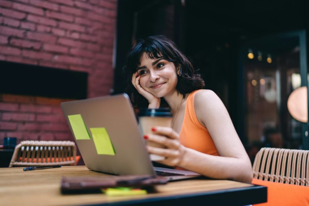 Female digital nomad working in cafe