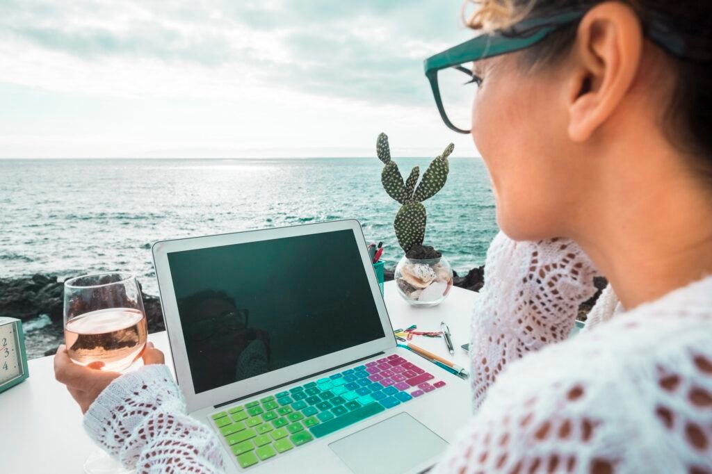 free digital nomad woman at work with a laptop outdoor sea view