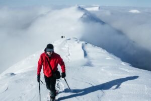 Leader climber walking ahead of team in snowy Gorgany mountains