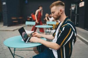 Male digital nomad working in cafe