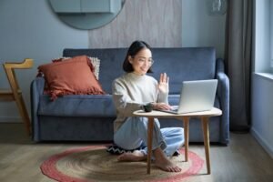 Portrait of young working woman, korean girl studying on remote online, talking to laptop, video