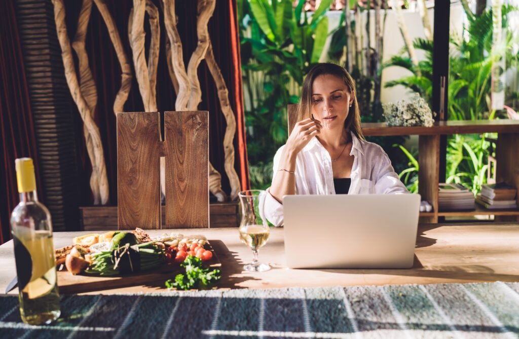 Skilled digital nomad texting and messaging during distance job on netbook