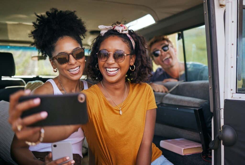 Travel, smile and selfie with friends on road trip in car for adventure, summer and freedom on Cali