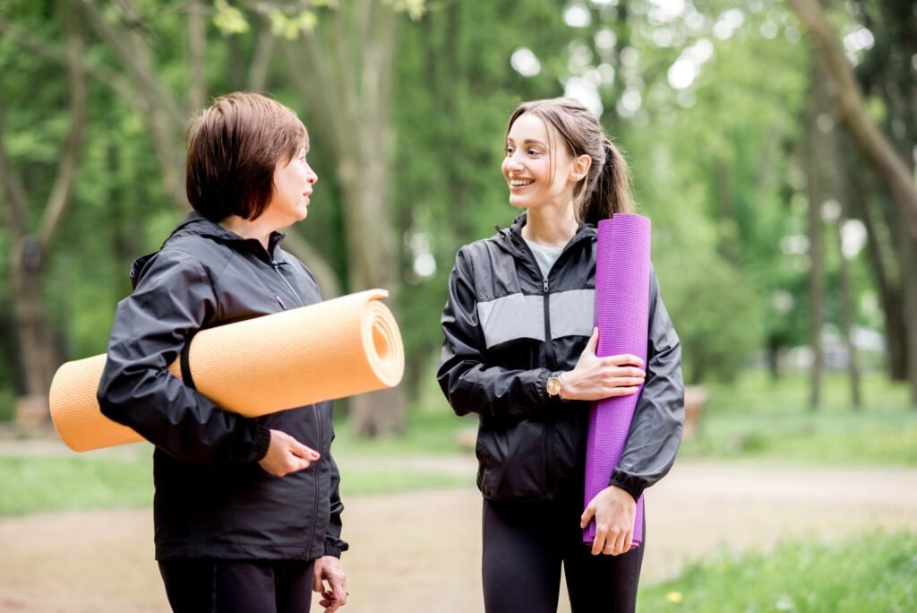 Women with yoga mats in the park