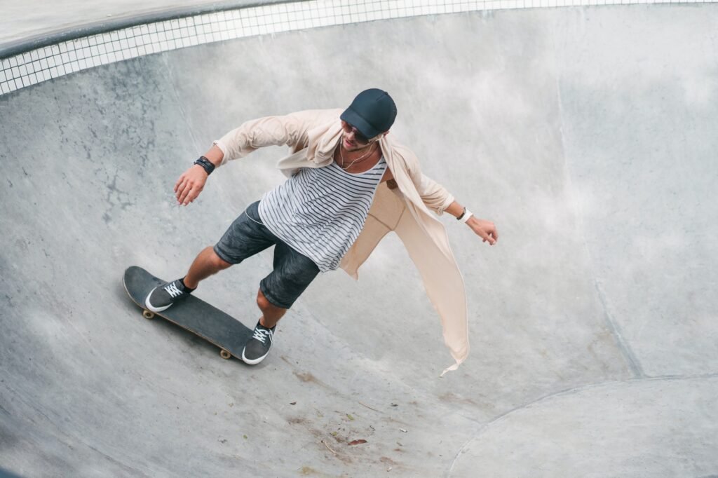 young skater skating on longboard in pool at skatepark