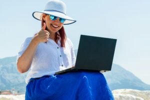 Digital Nomad Girl Working on Laptop at Seashore During Holiday
