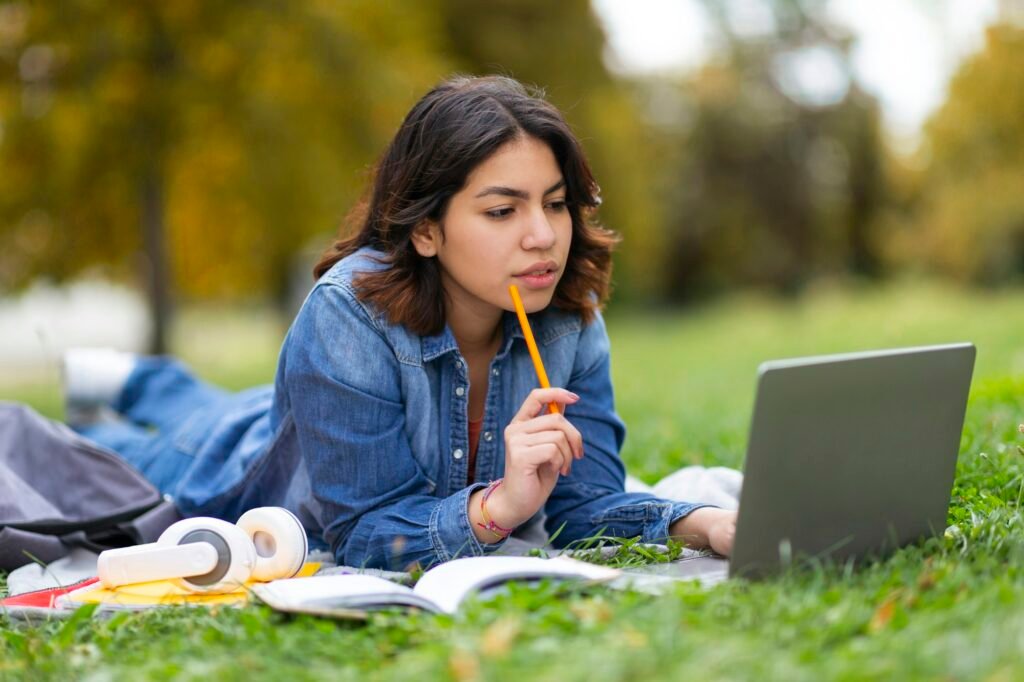 Learning Concept. Young Arab Student Female Studying Outdoors With Laptop