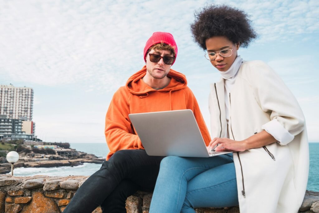 Two friends using a laptop.