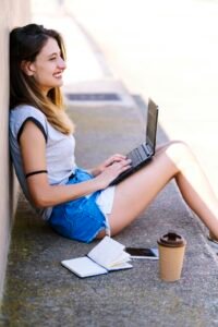 Digital nomad girl working from a natural setting.