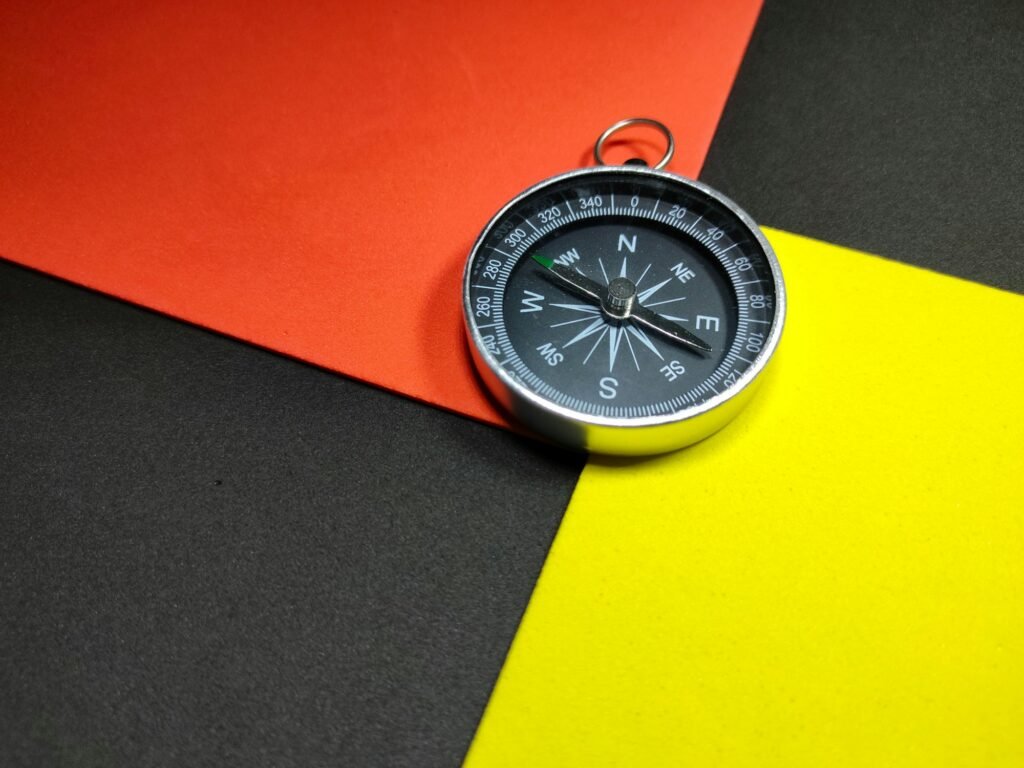 Selective focus.Compass with colorful background