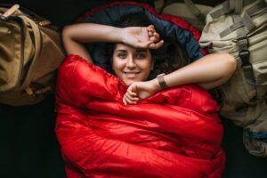 The traveler is resting in a sleeping bag. Rest concept. A tourist is resting in a tent