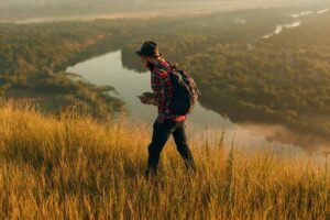 Traveler using smartphone in nature