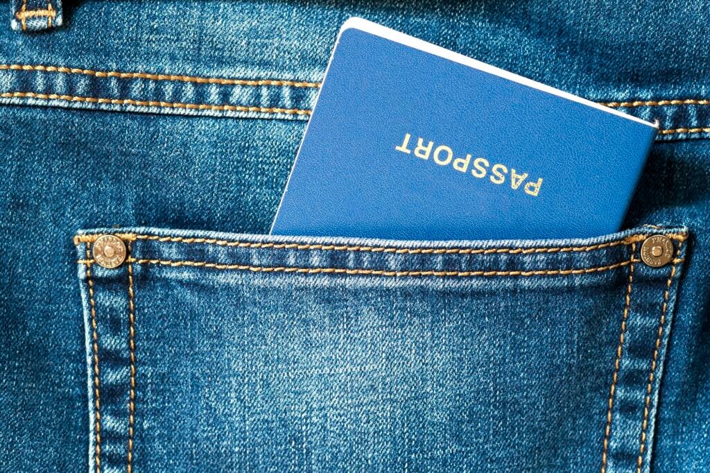 Travel passport in a pocket of blue jeans close up