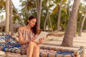 Digital nomad working on the beach while traveling